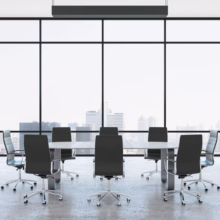 Modern conference room with a large table and ten sleek black chairs on wheels. Floor-to-ceiling windows showcase a city skyline, creating a bright, professional atmosphere.